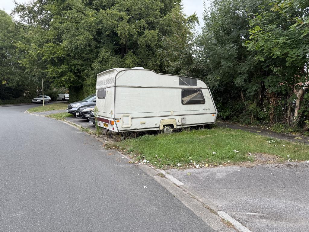 Lot: 36 - FREEHOLD PARCELS OF LAND, ACCESSWAYS AND PARKING AREAS - Hardstanding parking area with cars and caravan